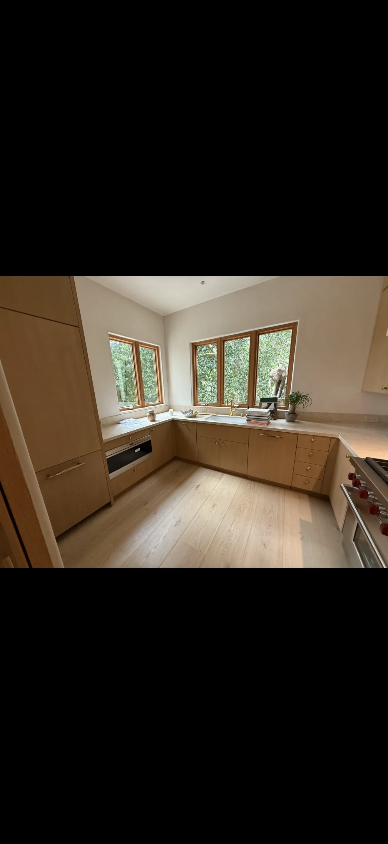 Finished natural wood kitchen cabinets and windows