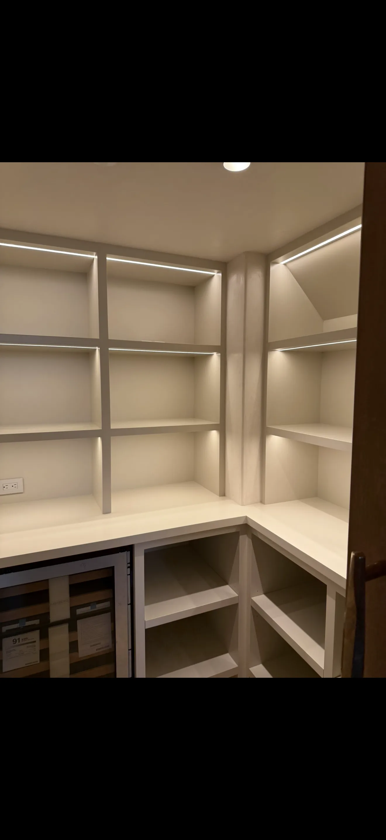 Finished built-in cabinetry with integrated lighting